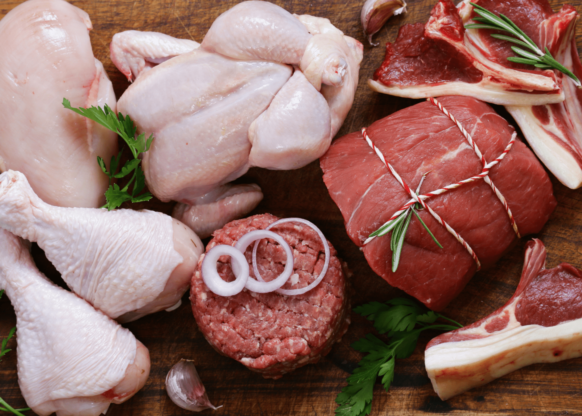 Assortment of raw meats including chicken, beef and pork