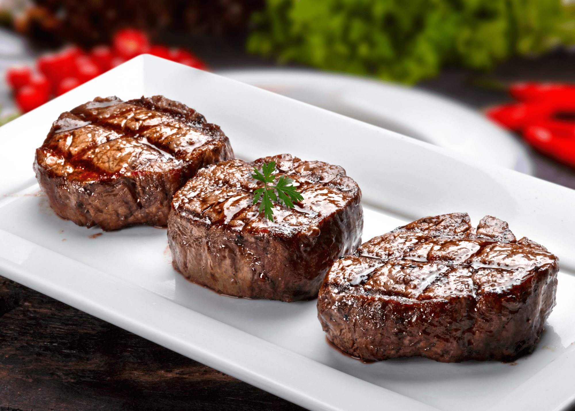 Seared steak medallions served on a white plate
